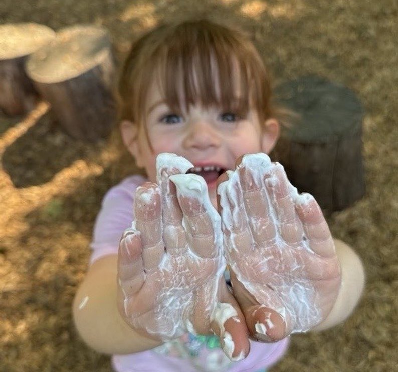 kid with hands covered with slime