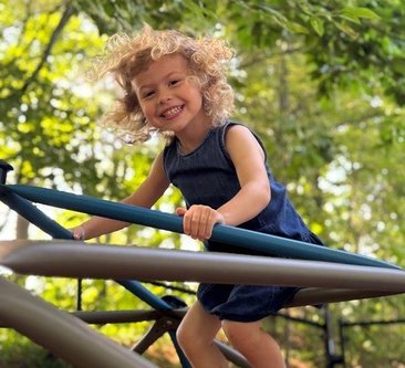 kid climbing playground equipment